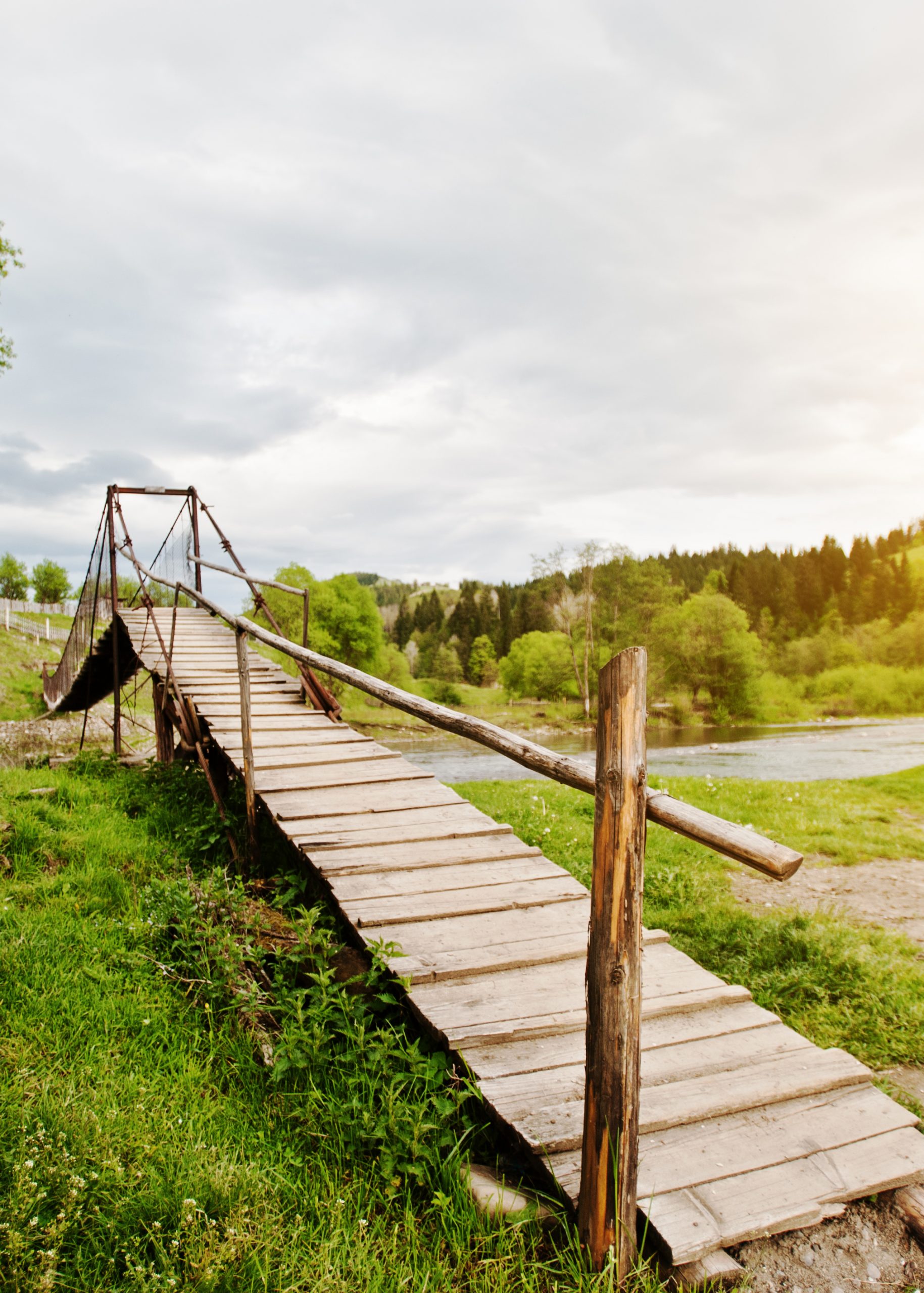 Wooden mountain suspension bridge of carpathian river